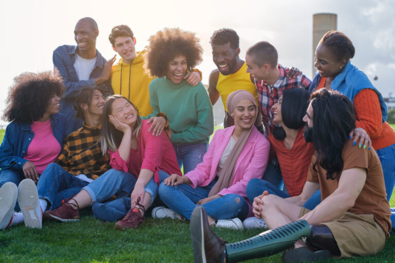 Group of friends sitting together outside
